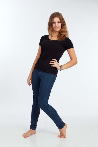 Girl in t-shirt and jeans on the white background