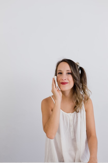 girl takes off her makeup with a cloth pad