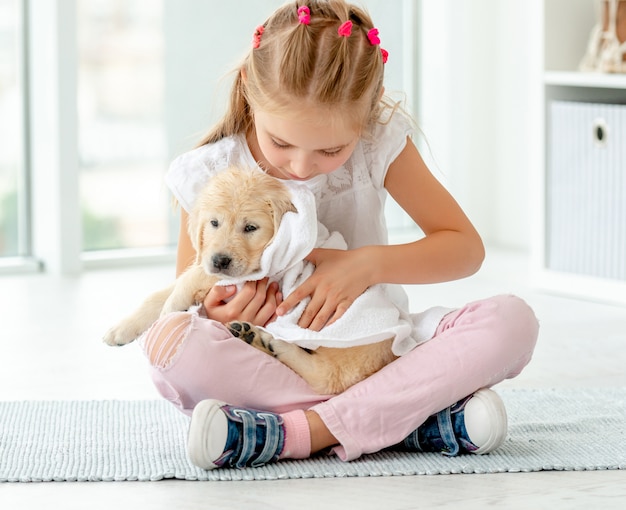 Girl taking care about puppy