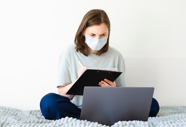 Girl taking notes in online courses