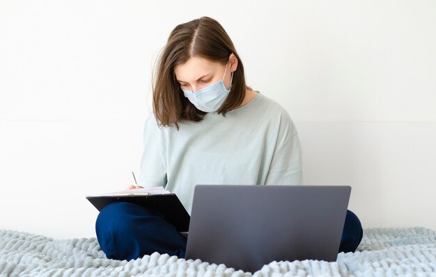 Girl taking notes in online courses