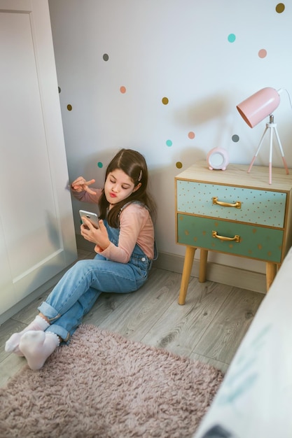 Photo girl taking selfie through smart phone at home