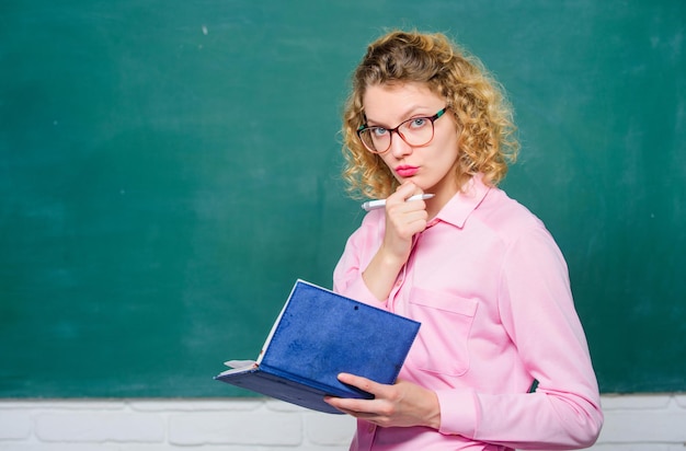 Girl teacher at private lesson. concentrated student in glasses at blackboard. essay writing. teacher with notebook. next school year. Girl prepare for exams. report project. back to school. notebook.