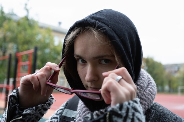 Girl teenager in autumn clothes on a city street