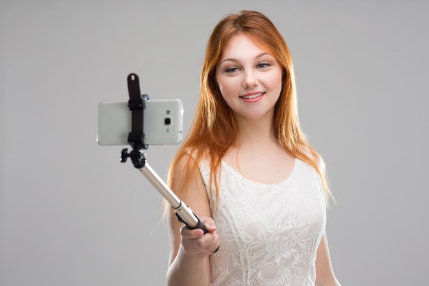 Girl teenager doing selfie with your phone