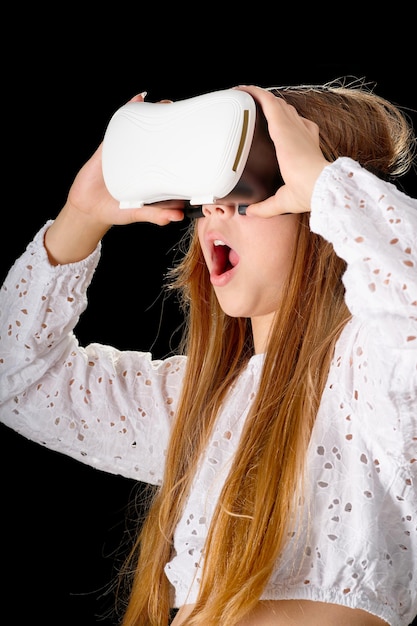 Girl teenager wearing VR glasses and interacting with virtual reality entertainment technology concept