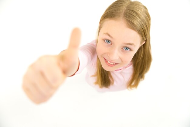 The girl thumbs up to the camera. View from above