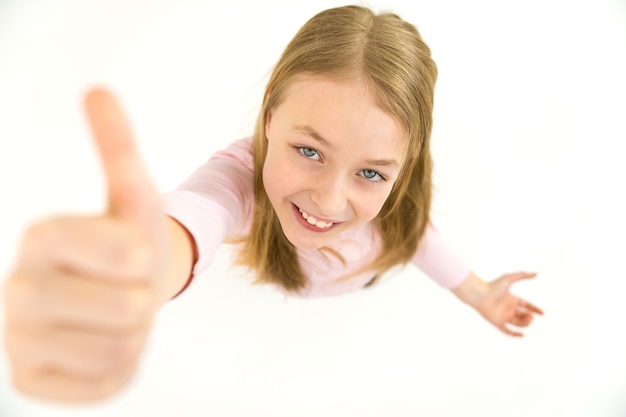 The girl thumbs up to the camera. View from above