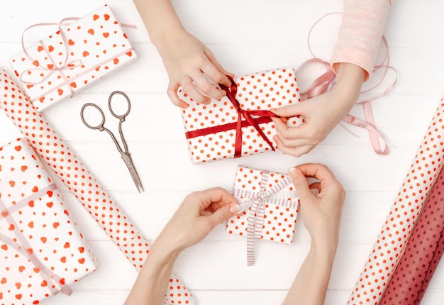 Girl tied ribbon on the gift