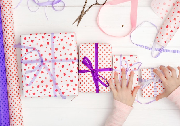 Girl tied ribbon on the gift