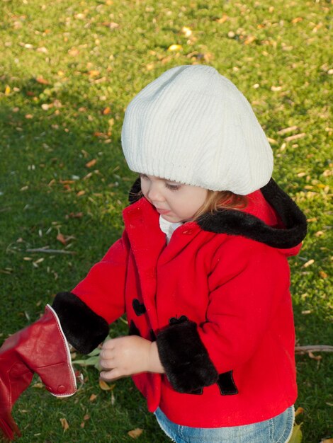 Girl toddler in autumn park.