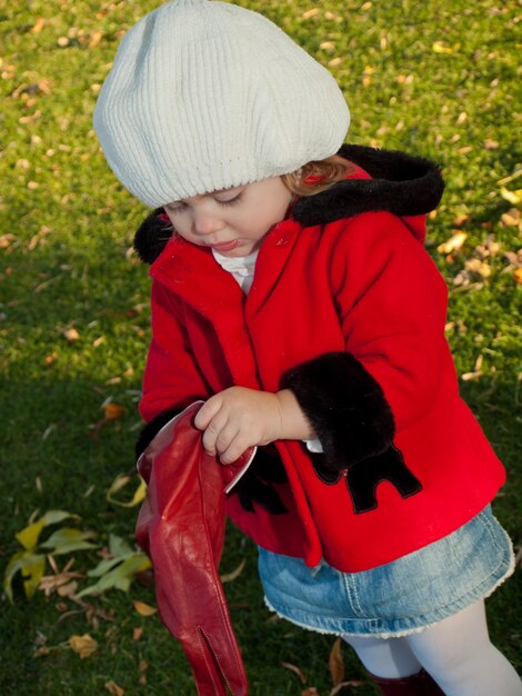 Girl toddler in autumn park.