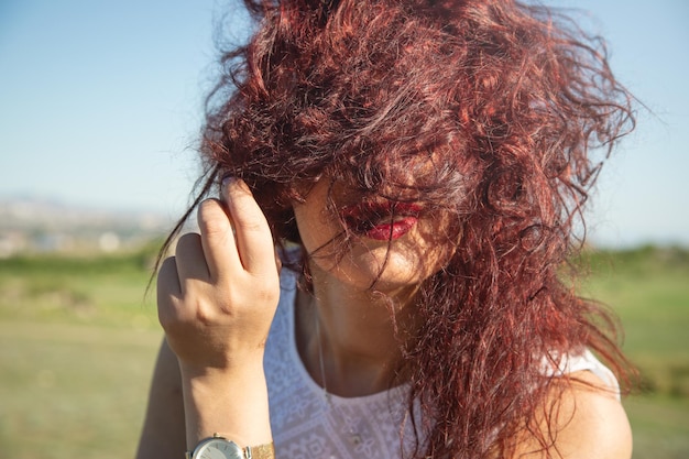 Girl touches the hair at outdoor