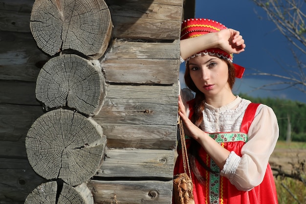 girl in traditional dress wooden wall