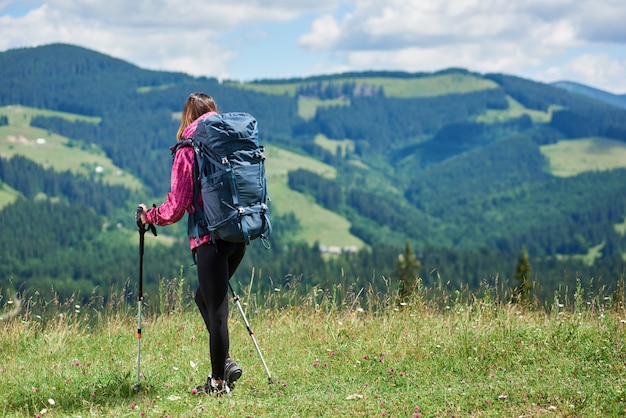 girl traveller climbing in the mountains