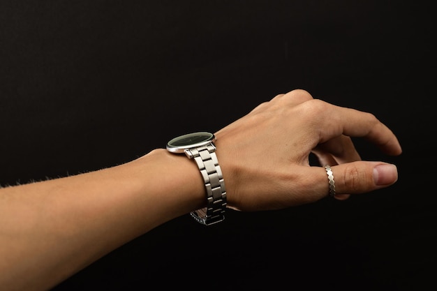 A girl tries on a hand watch in silver