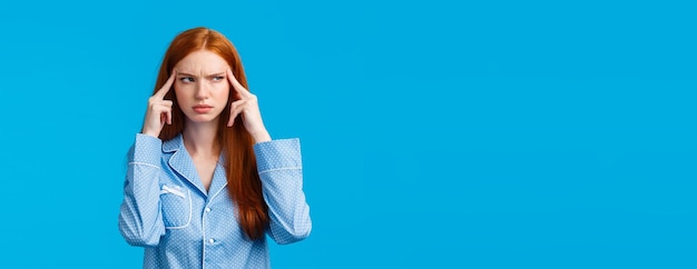 Girl trying focus and think straight seriouslooking thoughtful redhead creative woman squinting susp