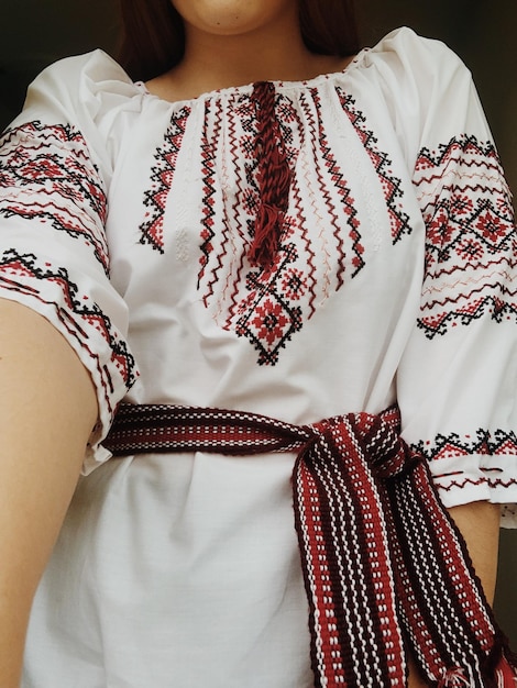 Photo a girl in a ukrainian embroidered shirt traditional clothes