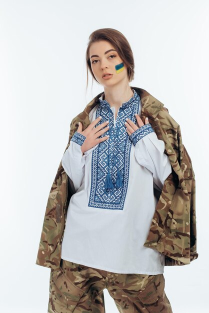 A girl in Ukrainian vyshyvanka holds a flag War in Ukraine on a white background