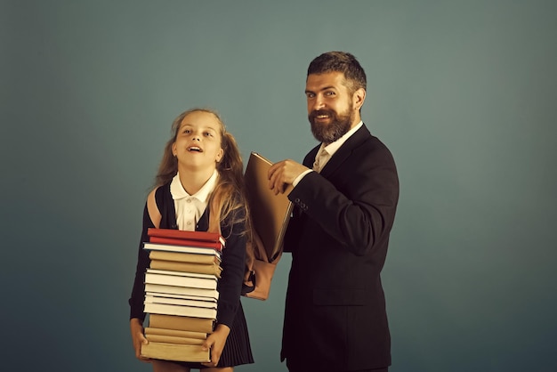 Girl in uniform and bearded man. Kid and tutor