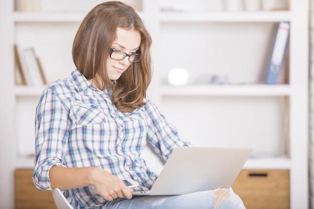 Girl using laptop computer side