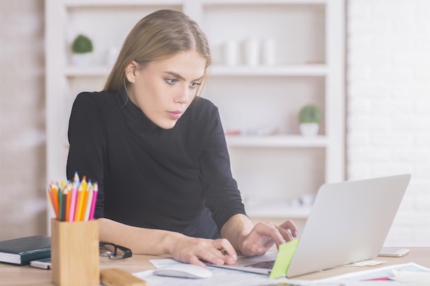 Girl using laptop at desk