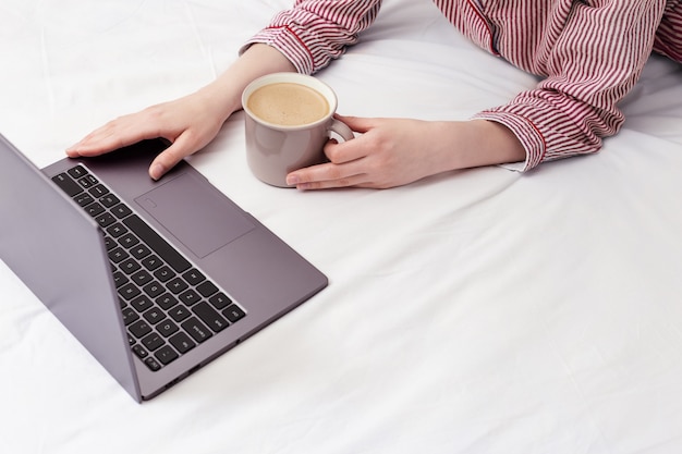 Girl using laptop and works at home.