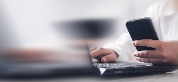 Girl using smartphone Modern office desk Technology