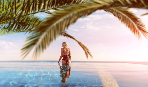 Foto la ragazza in vacanza si rilassa in una piscina tropicale