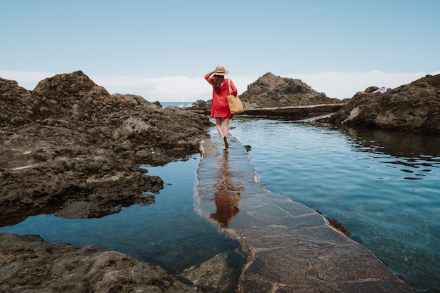 girl on vacation walking along the coast