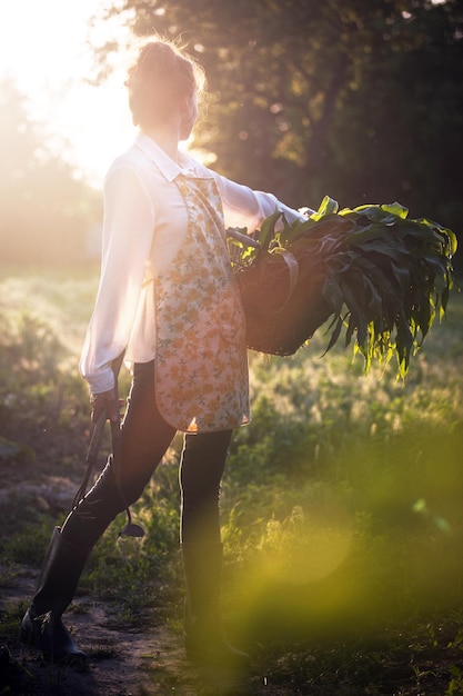 Girl in the village works in the garden