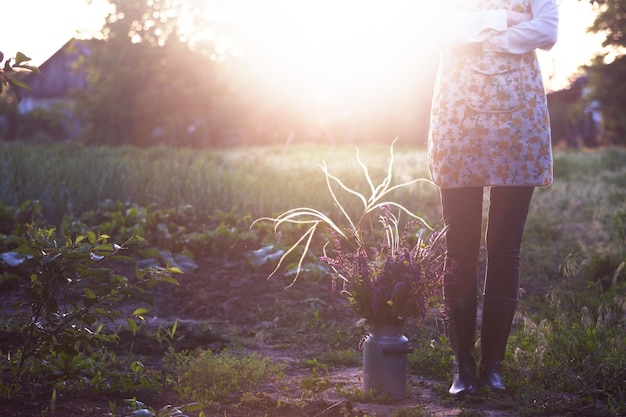 Girl in the village works in the garden