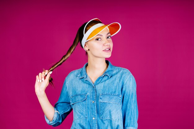 The girl in the visor twisted her long hair into a bundle and pulled sideways sideways looking at the screen