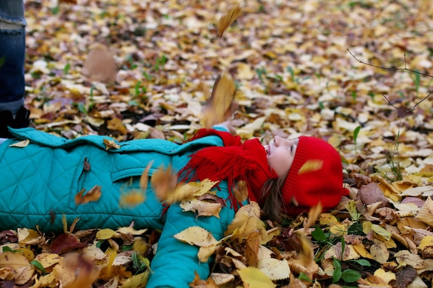 Girl on a walk in an autumn park during a fall leaf