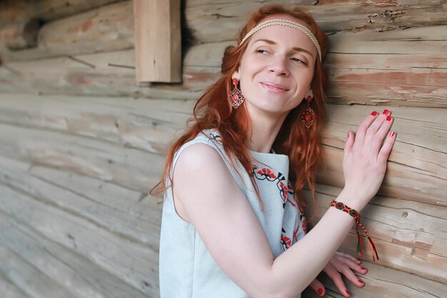 A girl on a walk in an autumn park. Young red-haired girl in the spring on nature.