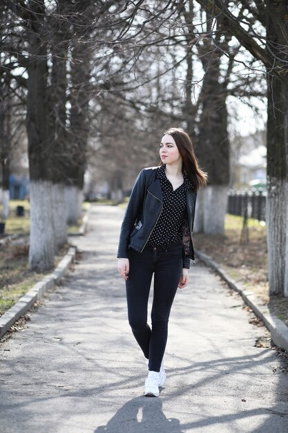 Girl on a walk through the spring city on a sunny day