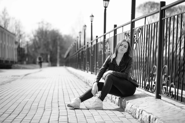 Girl on a walk through the spring city on a sunny day