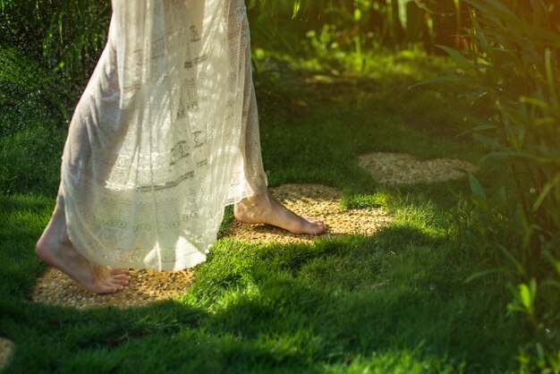 Girl walking barefoot on the stones in heart shape