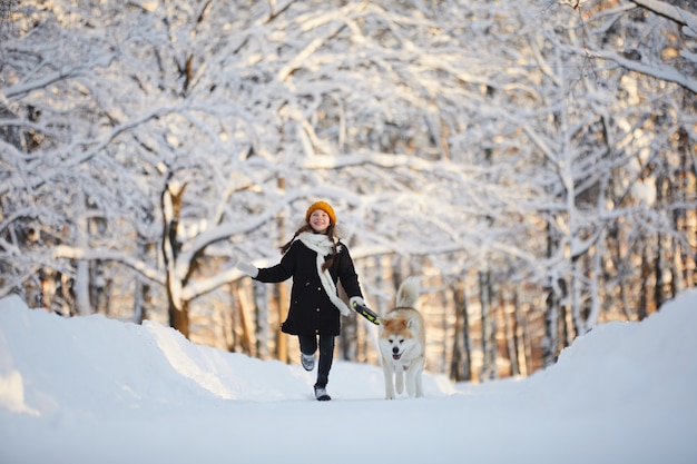 Girl Walking Dog in Winter Park