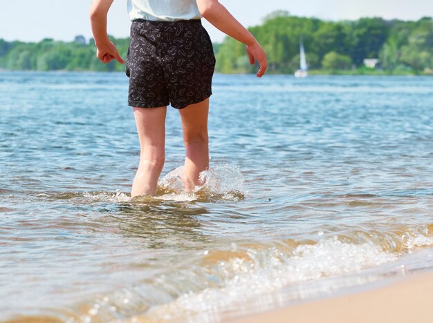 Girl walking in the water, summer vacation concept.