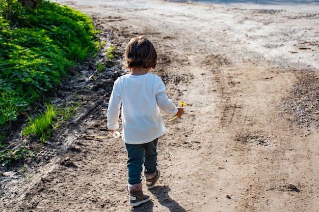 A girl walking with flowers in her hands