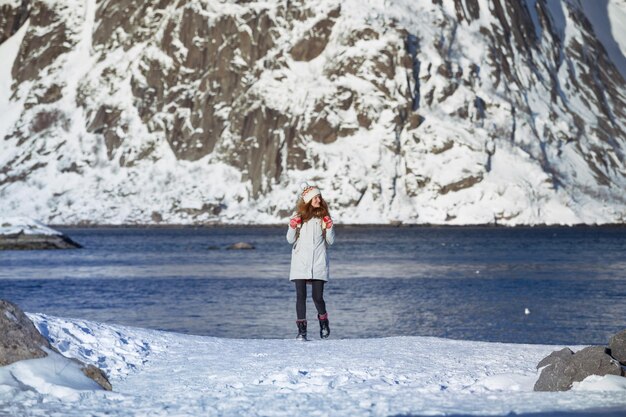 Foto una ragazza cammina lungo la riva del fiordo