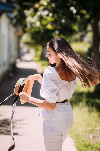 A girl walks around the city in the rays of the spring sun 3617