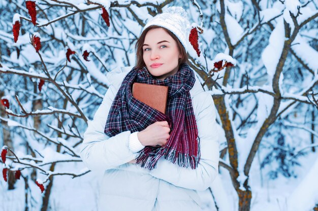 The girl walks through the winter forest