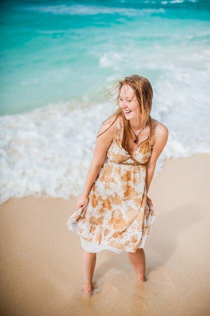 The girl walks on the water's edge on the Boracay