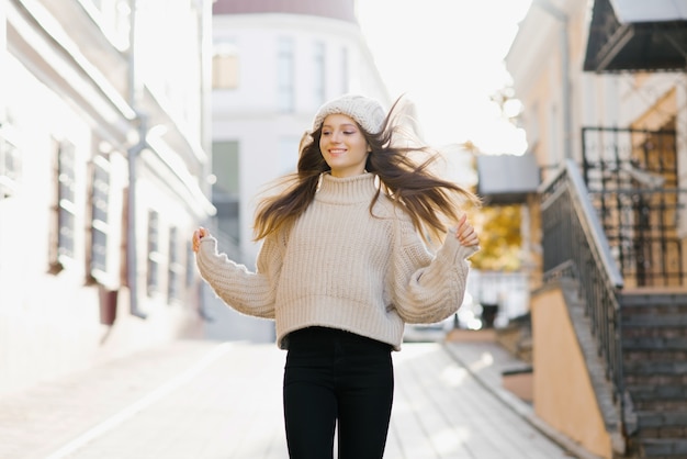 Girl in a warm sweater and hat running