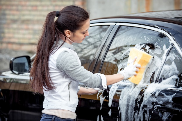 Girl washes the car