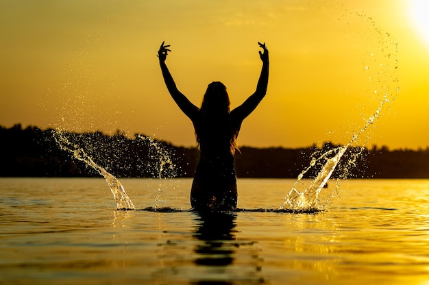 Girl in the water at sunset