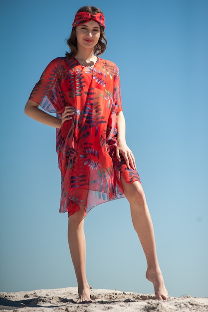 Girl wearing beach wear and posing at the sandy beach