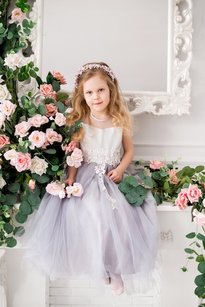 Girl wearing an elegant dress posing in a studio